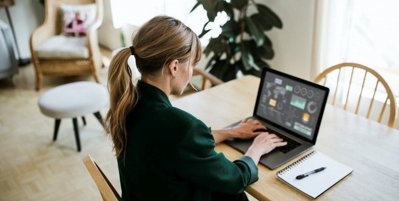 Woman working at a desk on laptop